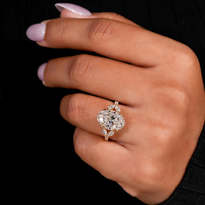 Engagement ring with yellow gold band, four round clear center gemstones in floral cluster design, worn on finger, top view

