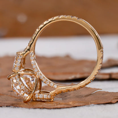Engagement ring with yellow gold band, oval clear center gemstone, pavé band, open gallery setting, side profile view
