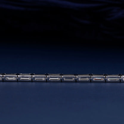Bracelet with white metal links, rectangular step-cut stones in tennis bracelet design, close-up rear detail view on a dark background
