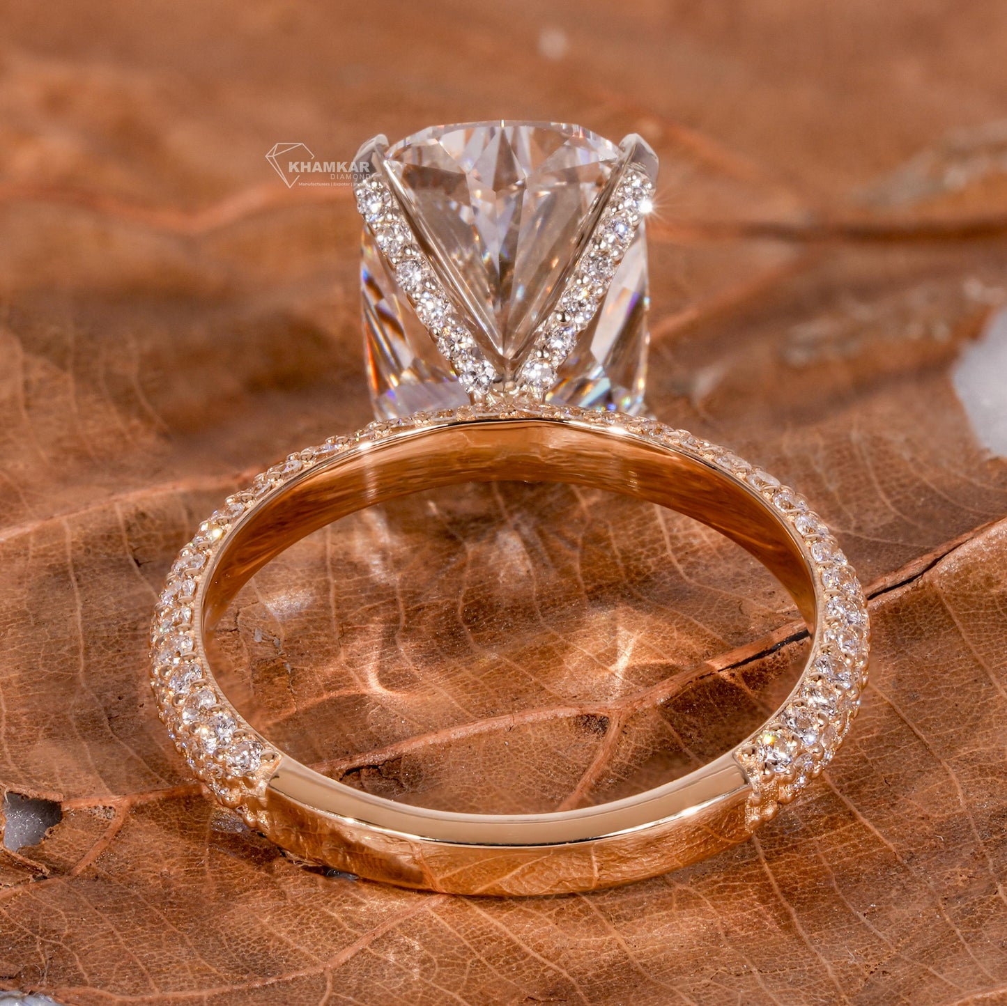 Engagement ring with rectangular clear gemstone, yellow metal pavé band, cathedral setting, rear view
