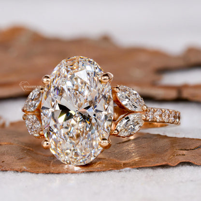 Engagement ring with yellow gold band, oval clear center gemstone, marquise side stones and pavé shoulders, angled front view 