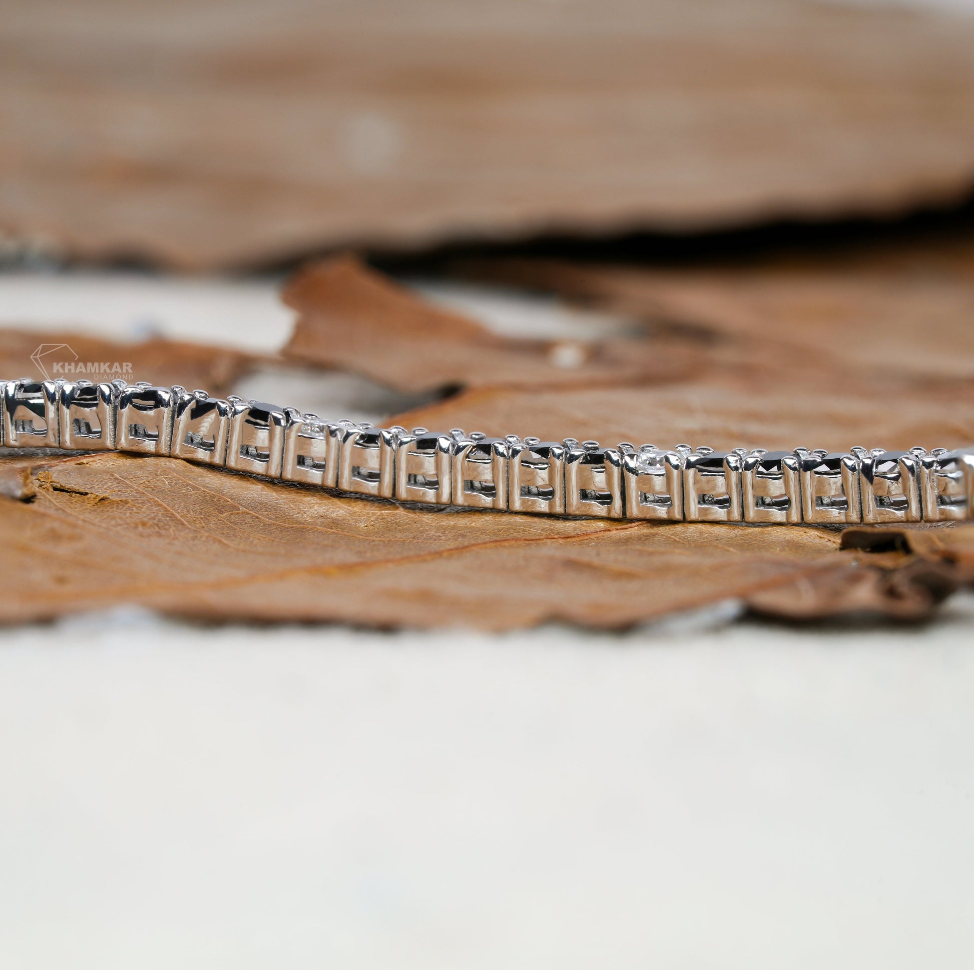 Bracelet with white metal rectangular link setting, side profile detail view, continuous line design, tennis bracelet jewelry
