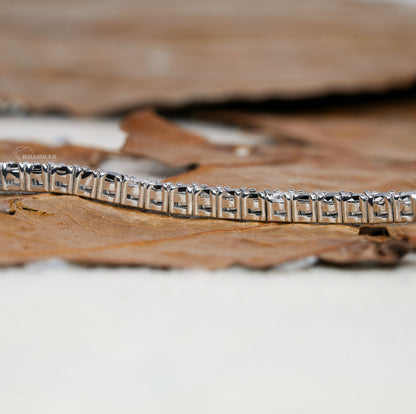 Bracelet with white metal rectangular link setting, side profile detail view, continuous line design, tennis bracelet jewelry

