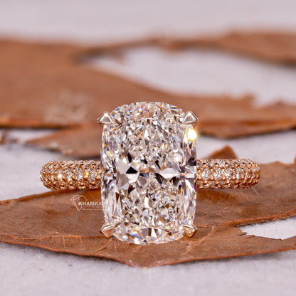Engagement ring with rectangular clear gemstone, polished yellow metal pavé band, four-prong setting, front view
