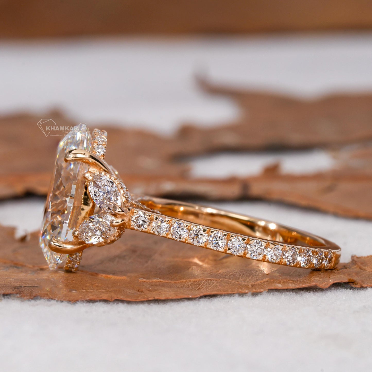 Engagement ring with yellow gold band, oval clear center gemstone, marquise side stones, pavé band, side profile view
