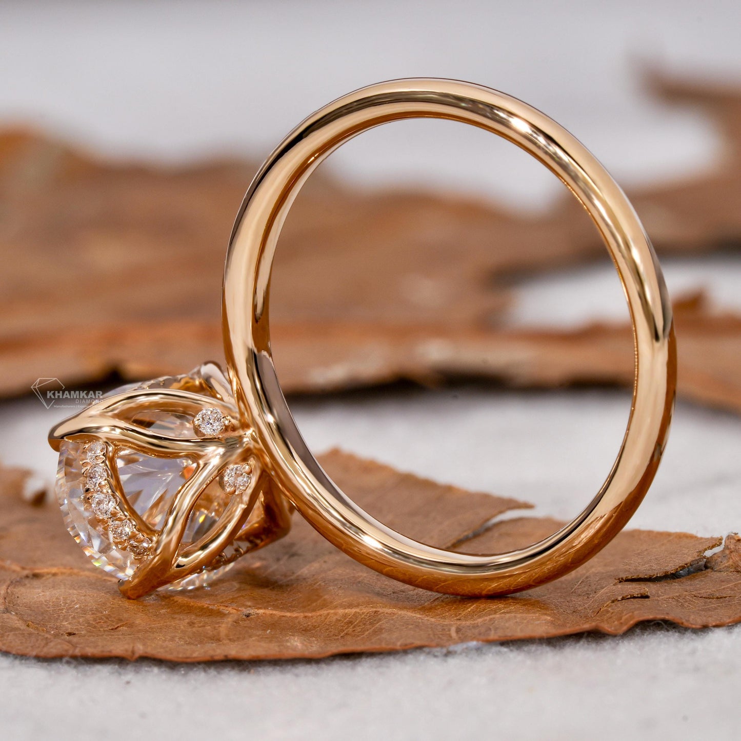 Engagement ring with yellow metal band, oval solitaire gemstone, open gallery with pavé accents, side rear view
