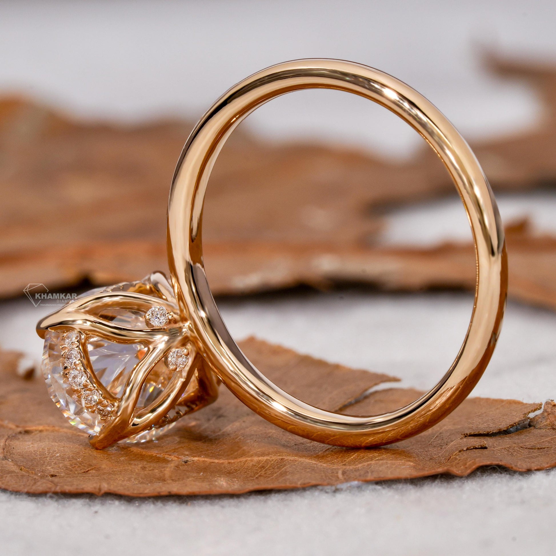 Engagement ring with yellow metal band, oval solitaire gemstone, open gallery with pavé accents, side rear view

