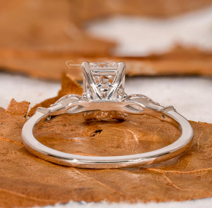 Engagement ring with white metal band, emerald-cut clear center stone, open gallery setting and marquise side stones, rear view
