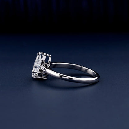 Solitaire ring with clear geometric center stone in raised prong setting and polished white metal band, side view
