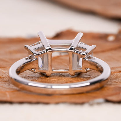Engagement ring with white metal band, empty rectangular four-prong center setting, open gallery design, rear view
