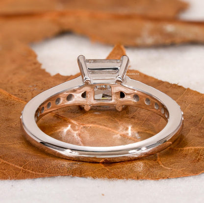 Engagement ring with white metal band, four-prong setting and open gallery, underside view with polished finish and circular accent openings
