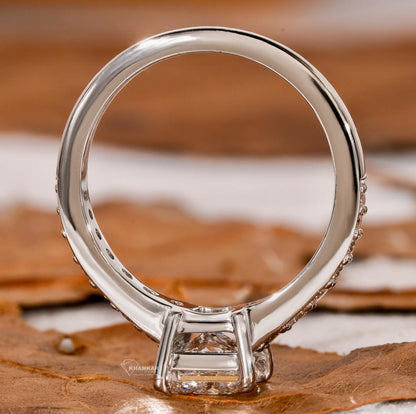 Engagement ring with white metal band, four-prong setting and open gallery, underside view with polished finish and raised basket design

