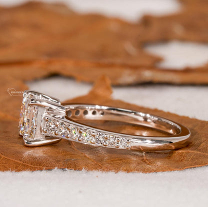 Engagement ring with white metal band, square center stone, pavé shoulders and raised four-prong setting, side profile view
