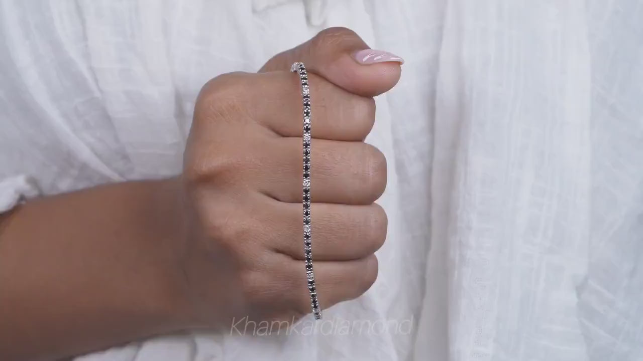 Bracelet with clear round stones in a continuous line setting, held across hand, close-up lifestyle view, tennis bracelet jewelry
