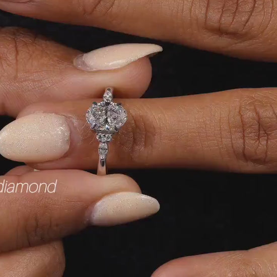 Engagement ring with round clear center gemstone, polished white metal band, small accent stones and front view on finger
