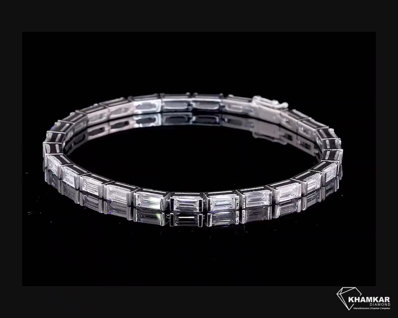 Bracelet with white metal links, rectangular step-cut stones in tennis bracelet design, top angled view on a black background
